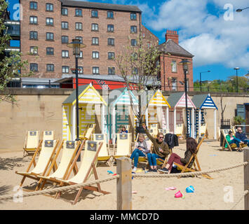 Newcastle upon Tyne,  England, UK. 10th May, 2018. Weather: A sunny day on the 'Quayside Seaside' pop up beach under Newcastle`s iconic Tyne Bridge on a glorious Thursday on the banks of the river tyne in Newcastle. Credit: ALAN DAWSON/Alamy Live News Stock Photo